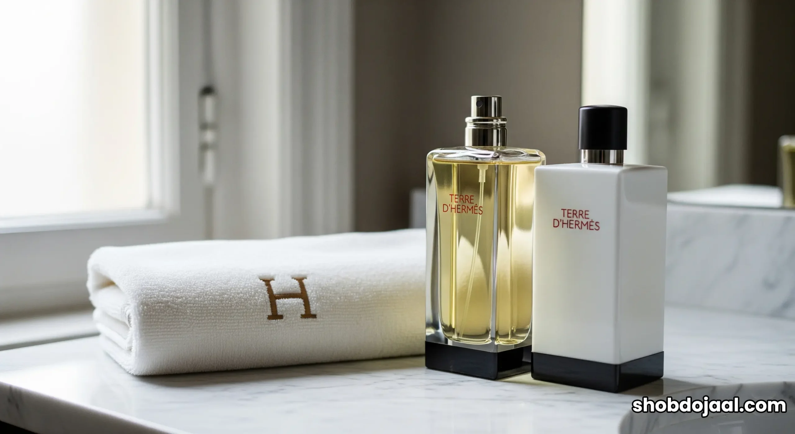 A collection of full-size Hermès luxury bath products displayed on a marble counter in a hotel suite.