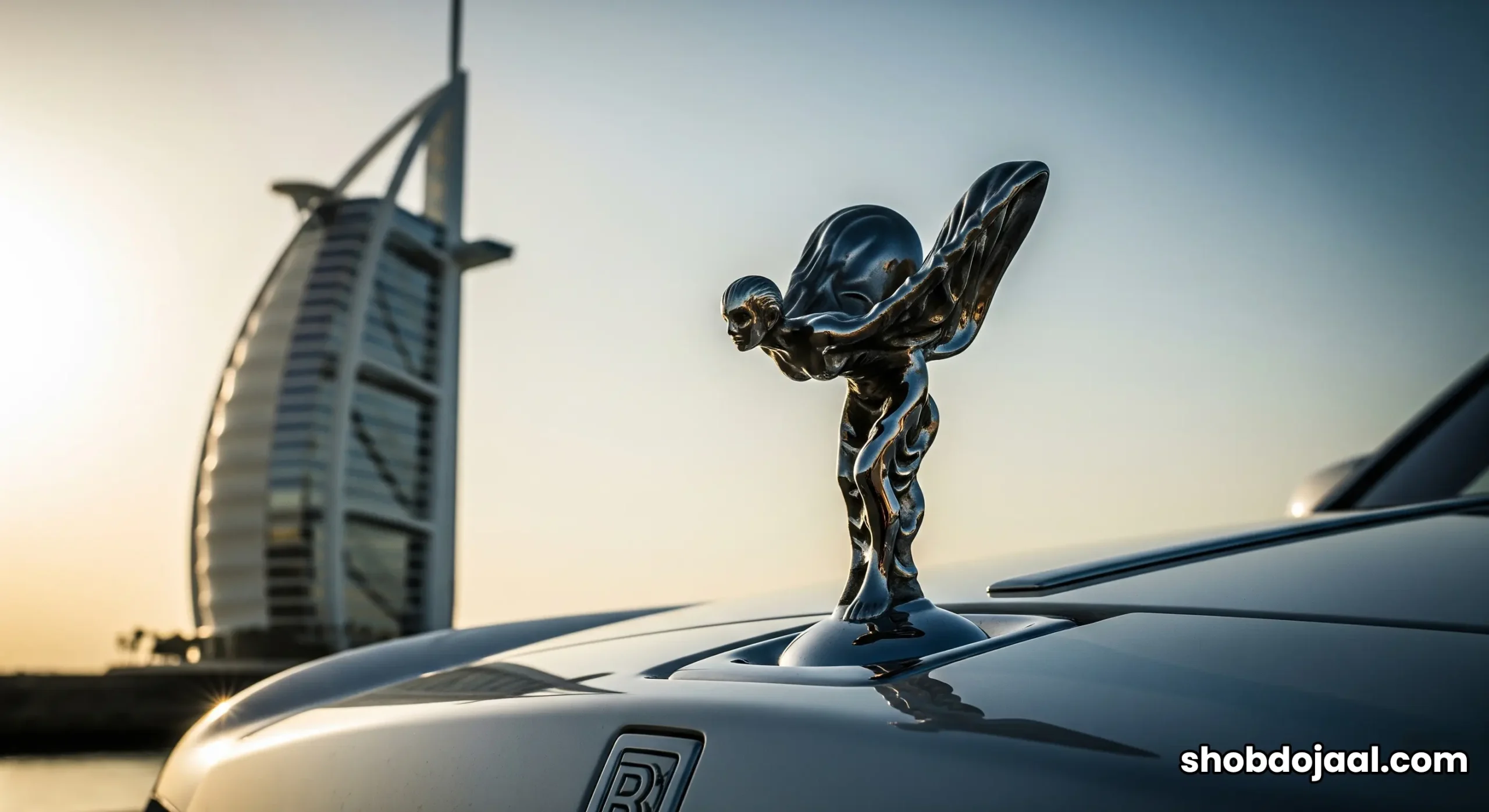 A fleet of white Rolls-Royce cars lined up in front of the iconic Burj Al Arab hotel.